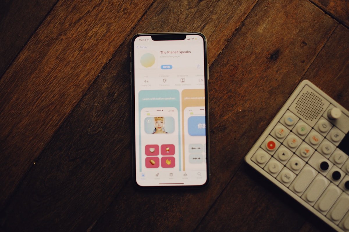 a cell phone sitting next to a remote control